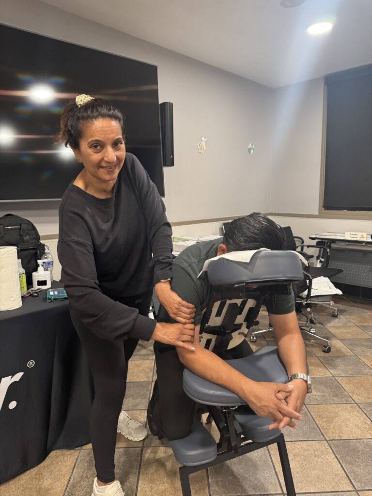 A woman receives a soothing back massage from a man, promoting relaxation and stress relief during the holiday season.