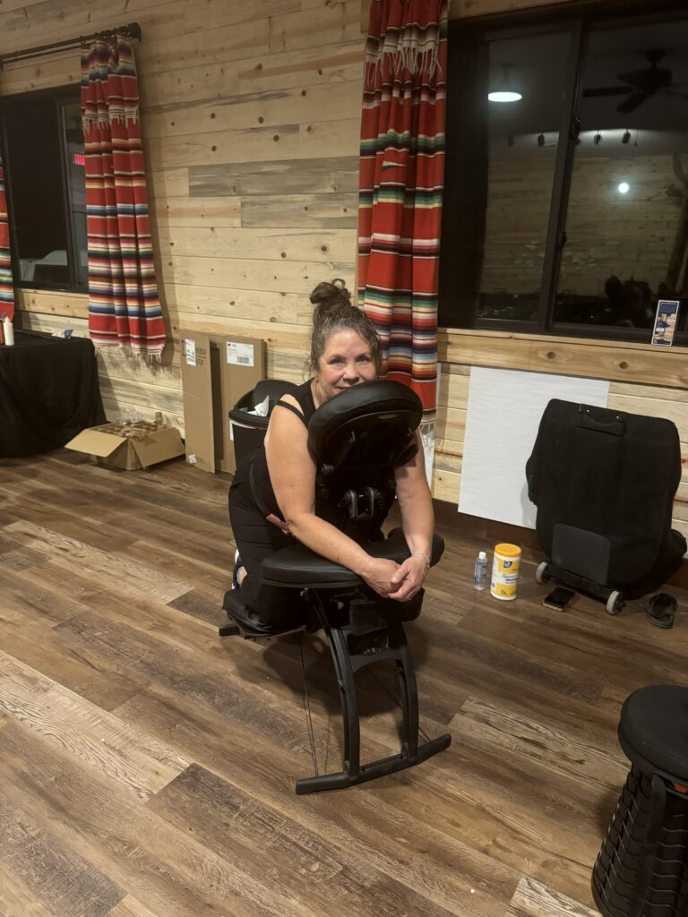 A woman seated in a chair, enjoying a moment of relaxation in a festive room setting.