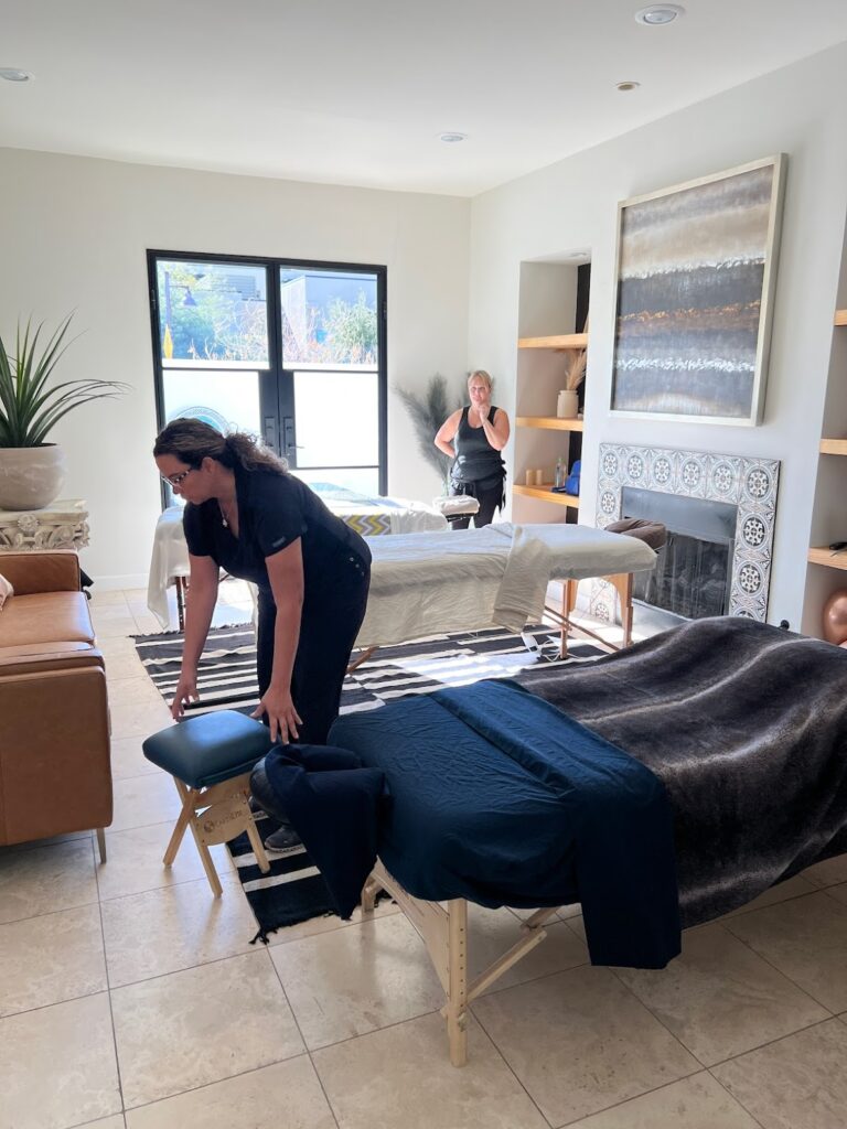 A woman enjoys a relaxing massage in a serene room, highlighting the benefits of professional home spa services.